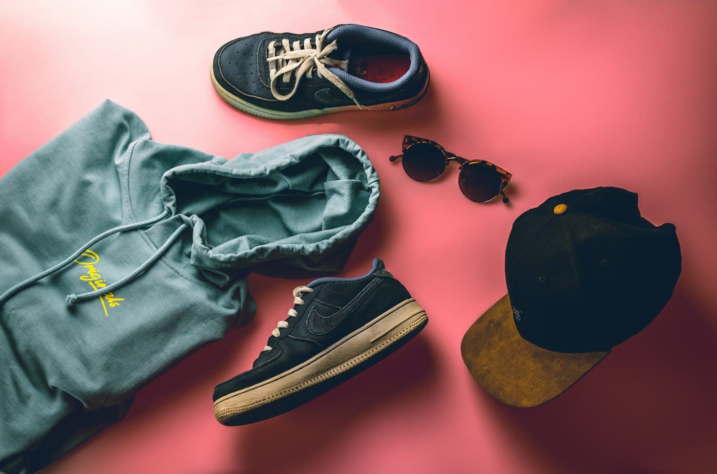 A cap laid out with other streetwear accessories