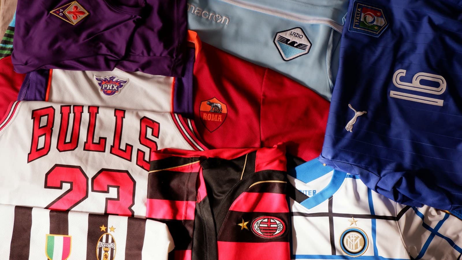 A pile of basketball and soccer jerseys